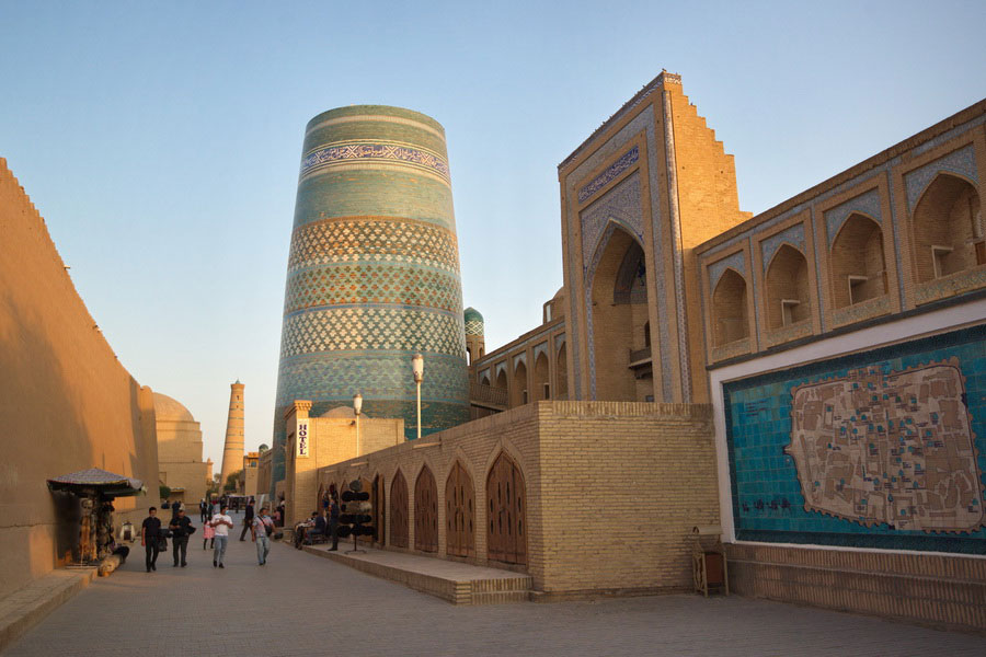 The stocky, brightly tiled turquoise cylinder of Kalta Minor minaret in Khiva