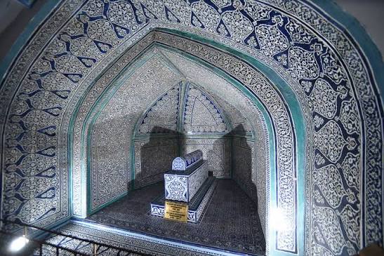 The radiant turquoise dome and tiled interior of Pahlavon Mahmud Mausoleum