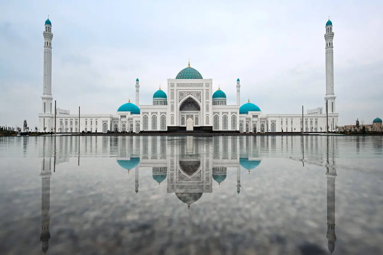 Marble colonnades and blue tiled dome of the Imam al-Bukhari complex