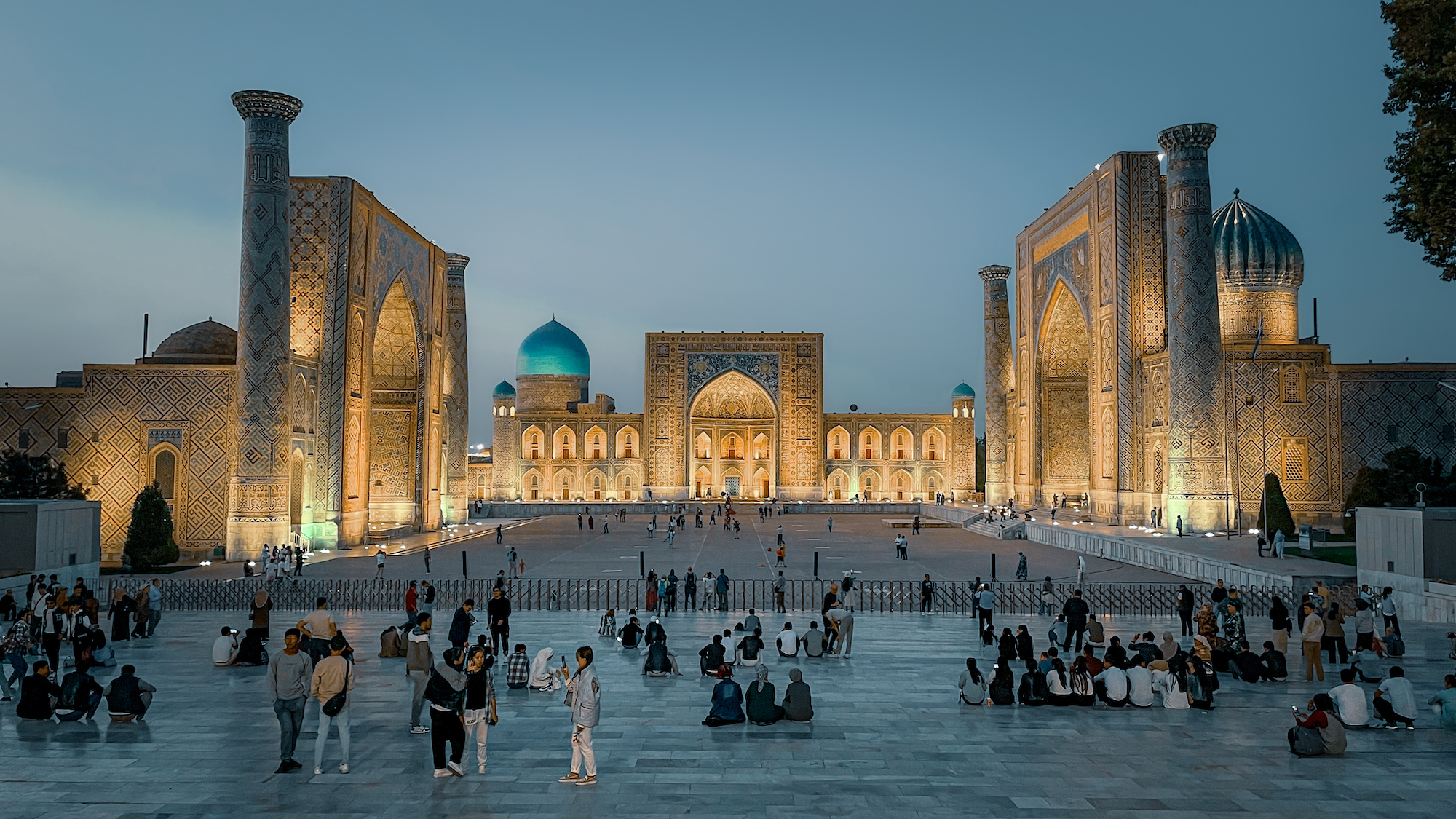 Registan Square in Samarkand with the three illuminated madrasas at twilight