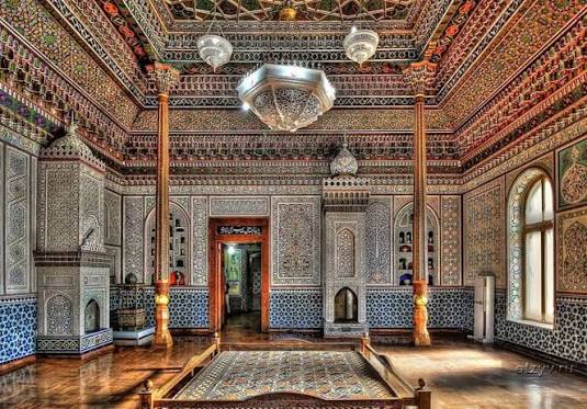 Intricate carved wood ceiling and vibrant suzani embroideries in the State Museum of Applied Arts in Tashkent