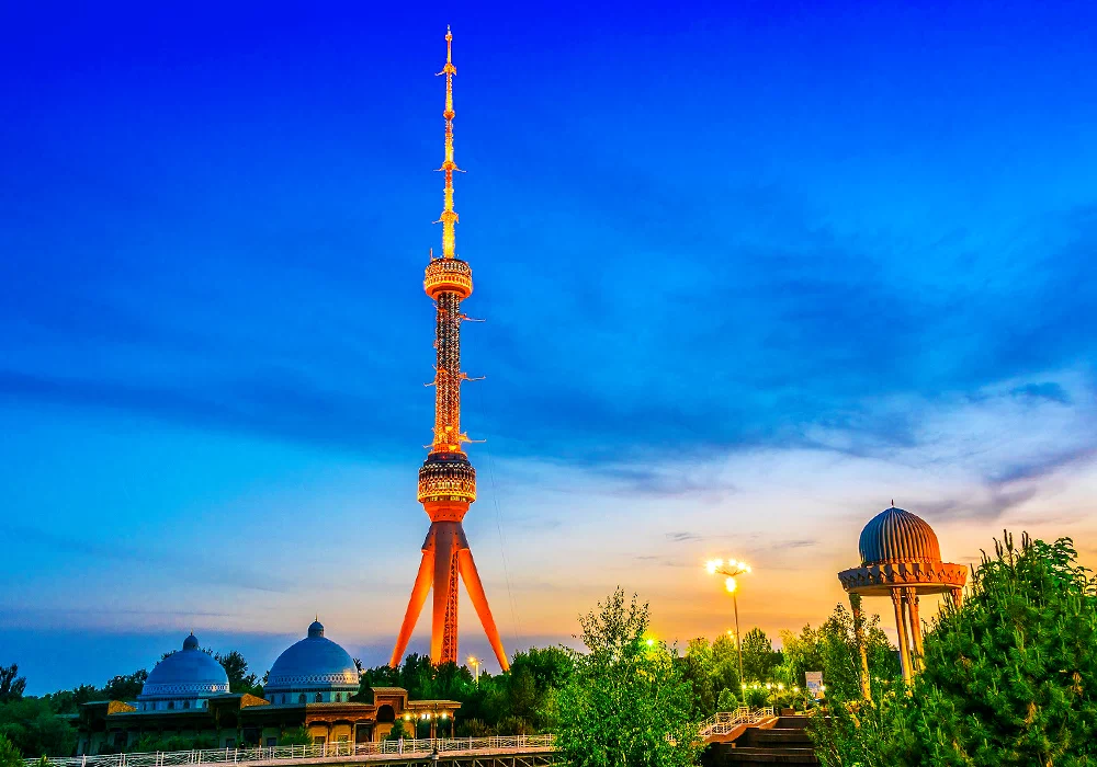 Tashkent TV Tower rising high into the blue sky above parks and city skyline in Tashkent